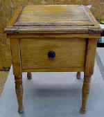 A childs antique commode before repairs.