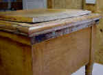 A childs antique commode before repairs close-up.
