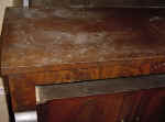 An antique sideboard top closeup before repairs.