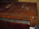 An antique sideboard top closeup before repairs.
